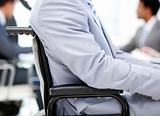 Close-up of a businessman sitting on a wheelchair