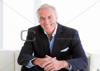 Happy senior businessman sitting on a sofa