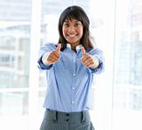 Successful female executive with thumbs up standing