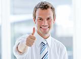 Portrait of a cheerful businessman with a thumb up