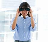 Business woman looking through Binoculars