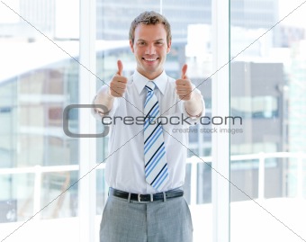 Portrait of a successful businessman with thumbs up