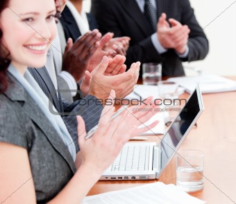 Cheerful business people applauding a good presentation