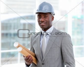 Portrait of a charismatic male architect holding blueprints