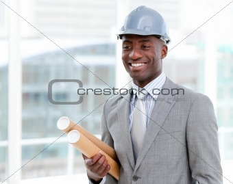 Portrait of a cheerful male architect holding blueprints