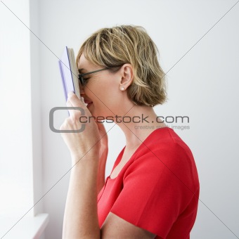 Woman reading book.