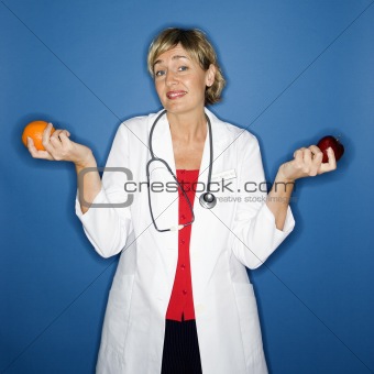 Doctor holding fruit. 