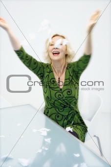 Businesswoman throwing paper
