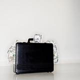 Briefcase overflowing with money