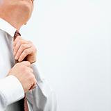 Businessman tying necktie
