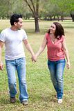 Couple walking holding hands and smiling