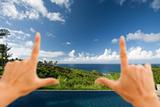 Hands Framing Breathtaking Hawaiian Ocean View Deck and Pool with Deep Blue Sky
