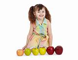 Happy child with apples of different color and size