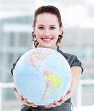 Charismatic businesswoman holding a terrestrial globe 