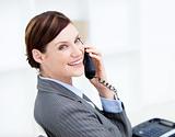Confident businesswoman on phone sitting at her desk 