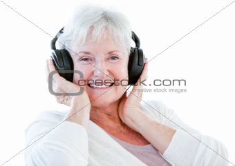 Smiling senior woman listening music with headphones 