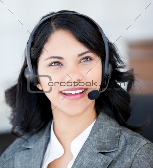 Smiling businesswoman wearing a headset to talk with customer