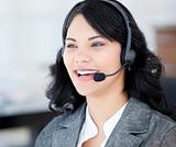 Joyful businesswoman wearing a headset to talk with customer