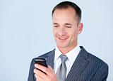 Handsome businessman sending a text with his  phone 