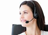 Confident  businesswoman wearing a headset to talk with customer