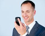 Self-assured businessman sending a text with his  phone