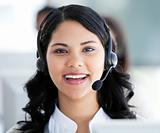 Beautiful businesswoman wearing a headset to talk with customer 