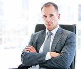 Confident businessman looking at the camera sitting 