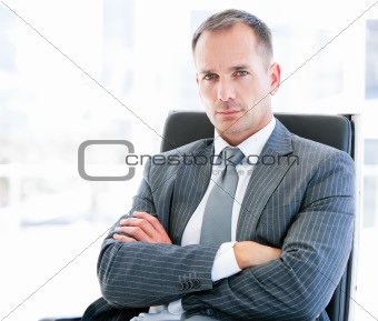 Confident businessman looking at the camera sitting 