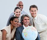Multi-ethnic businessteam holding a globe in the office