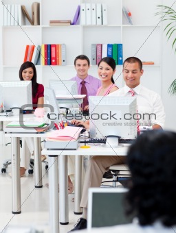Smiling business people working at computers