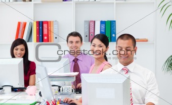 Positive business people working at computers