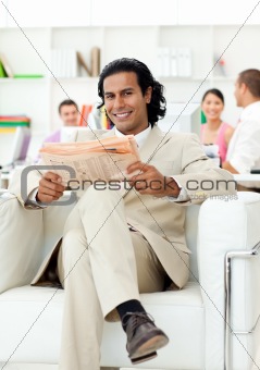 Self-assured manager reading a newspaper