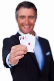 Smiling businessman holding all the aces 