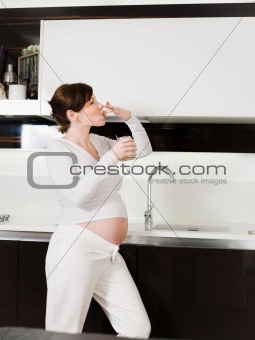 pregnant woman eating honey from the jar