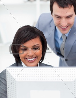 Two positive colleagues working at a computer