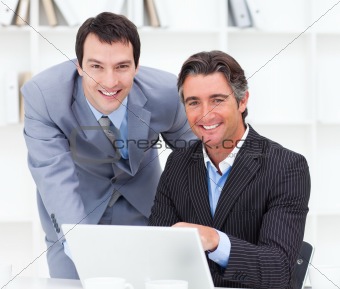 Close-up of two businessmen working at a computer