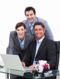 Merry business team working at a computer