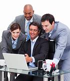 Multi-cultural business team working at a computer