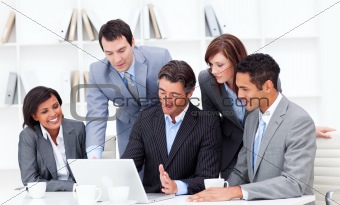 Serious multi-ethnic business partners working at a laptop