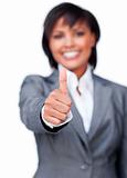 Smiling businesswoman with thumb up smiling at the camera