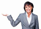 Hispanic businesswoman with open palm smiling at the camera