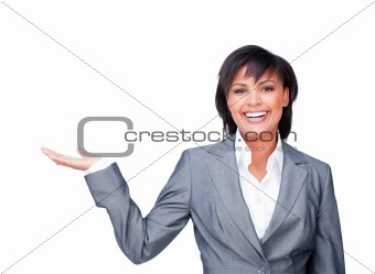 Young businesswoman with open palm smiling at the camera 