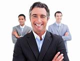Enthusiastic businessman posing in front of his team