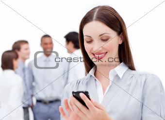Smiling businesswoman sending a text