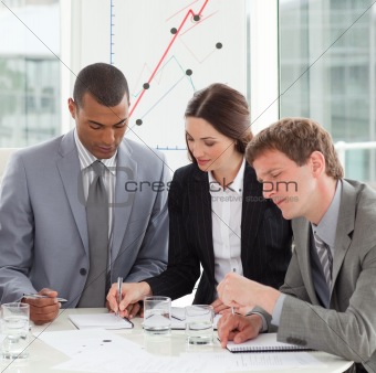 Concentrated business people studying sales report