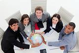 Smiling Business team holding a terrestrial globe