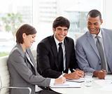 Attractive young businessman smiling at the camera in a meeting