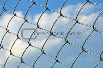 Metal wire fence against sky - slight side view