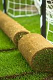 Turf grass rolls on football field
