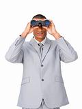 Attractive Ethnic businessman using binoculars 